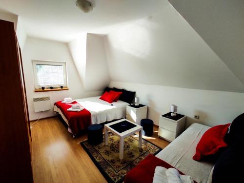 a room with two beds and a table in it at BonaMi Divcibare in Divčibare