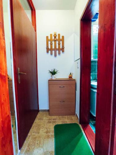 a hallway with a room with a dresser and a mirror at BonaMi Divcibare in Divčibare