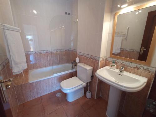 y baño con aseo, lavabo y bañera. en Apartamento en Islantilla Golf, en Islantilla