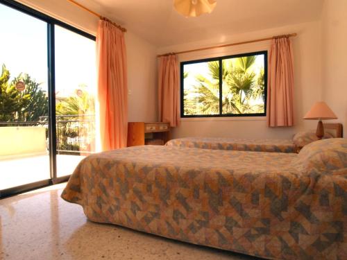 A bed or beds in a room at Tavros Hotel Apartments