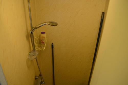 a shower stall with a door and a bottle of milk at Stuga i Pålles Stugby in Duved