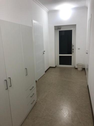 an empty room with white cabinets and a toilet at SleepRestFly in Boryspilʼ