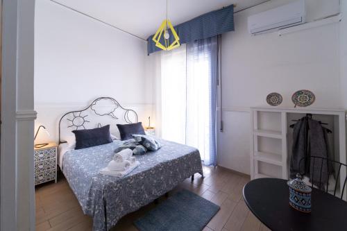 Schlafzimmer mit einem Bett mit blauer Decke in der Unterkunft Hotel Bella Capri in Neapel