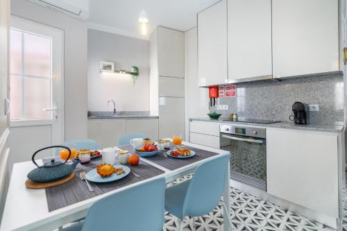 a kitchen with a table with food on it at Heritage House Leiria in Leiria