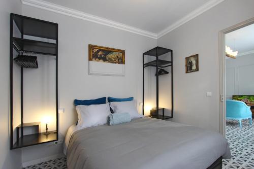a bedroom with a large bed with black shelves at Heritage House Leiria in Leiria