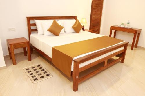 a bedroom with a large bed and two night stands at Hotel Nilketha Yala Tissamaharama in Tissamaharama
