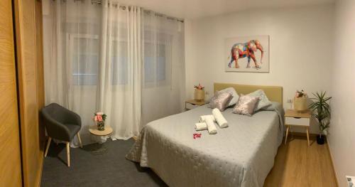 a bedroom with a bed with two candles on it at Vigo centro ciudad, con garaje in Vigo