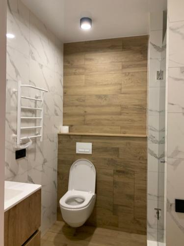 a bathroom with a toilet and a sink at Apartment near the airport in Boryspilʼ