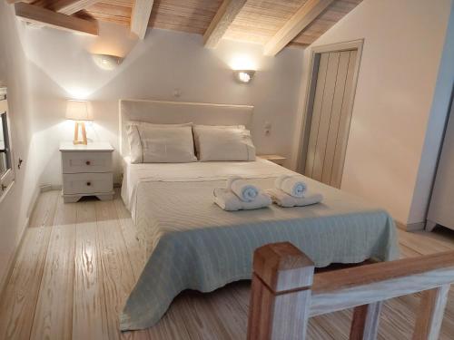 a bedroom with a bed with two towels on it at Simos suites in Elafonisos