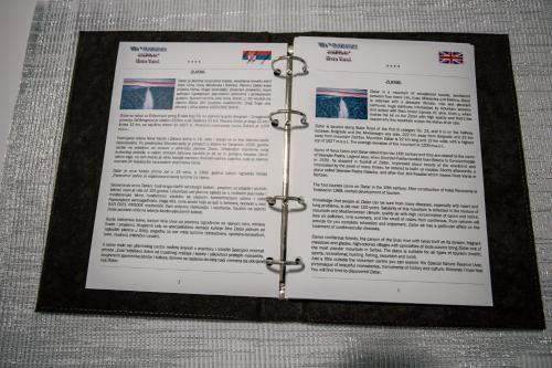 a piece of paper on a table with a metal bracket at Vila ZLATARSKA PAHULJA in Nova Varoš