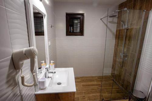 a bathroom with a sink and a shower at Vila ZLATARSKA PAHULJA in Nova Varoš