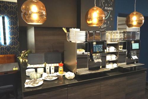 a restaurant with a counter with plates of food at Boutique Hotel Germania in Munich
