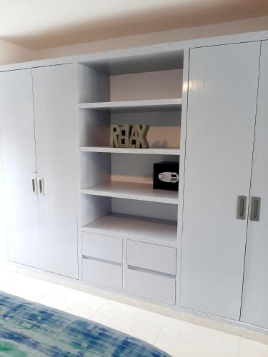 a white closet with white cabinets in a room at Ocean Villa in Puerto Morelos