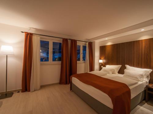 a bedroom with a large bed and a window at Aparthotel Miramare in Makarska