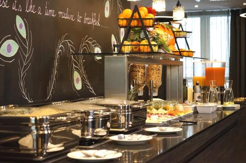 a buffet line with plates of food on it at Boutique Hotel Germania in Munich