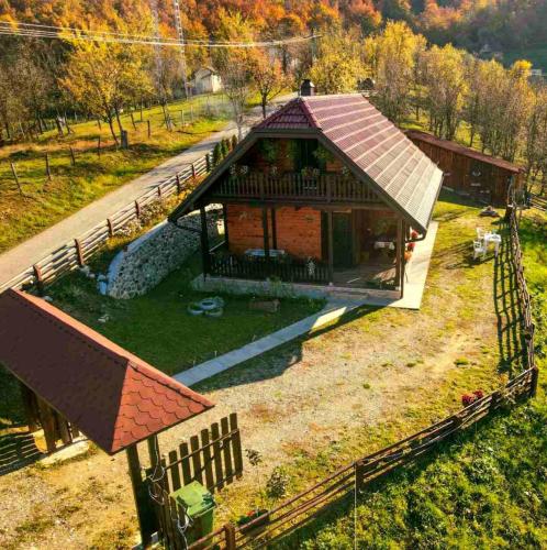 a small house with a roof on a field at Brvnara Sofiana in Bajina Bašta