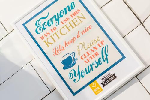 a packet of coffee signs on a white tiled floor at Hostal El Perelló, Valencia in El Perelló