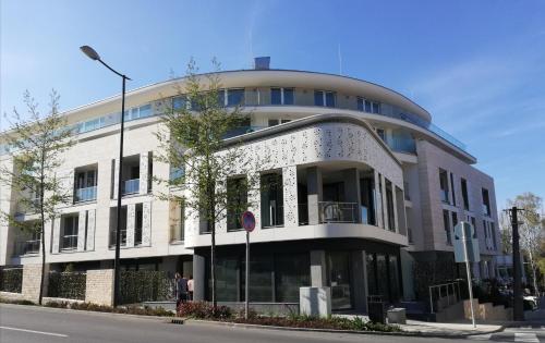a large white building with a round top at Spa Residence Carbona Apartment 105 in Hévíz