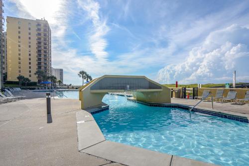 a swimming pool with a building in the water at Phoenix 6 Unit 1015 in Orange Beach
