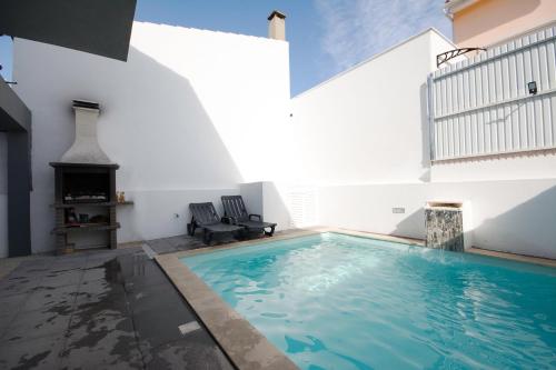 a swimming pool in the middle of a house at Summer holiday in Fernao Ferro