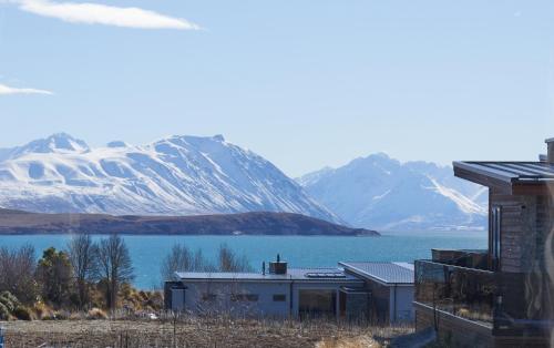 a house with a view of a lake and mountains at Majestic View - Lake Tekapo in Lake Tekapo