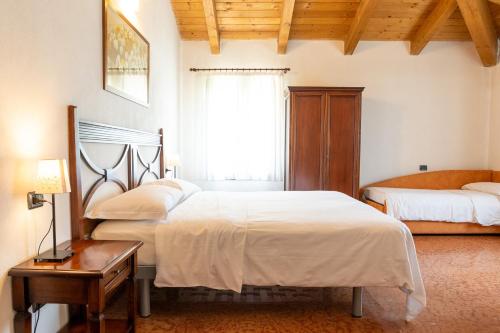 A bed or beds in a room at Agriturismo Cà Nuova