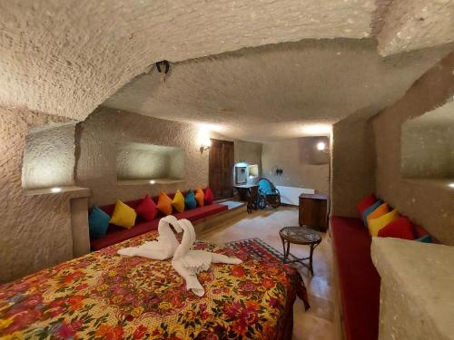 a bedroom with two swans laying on a bed at ARMEsos Cave Hotel in Urgup