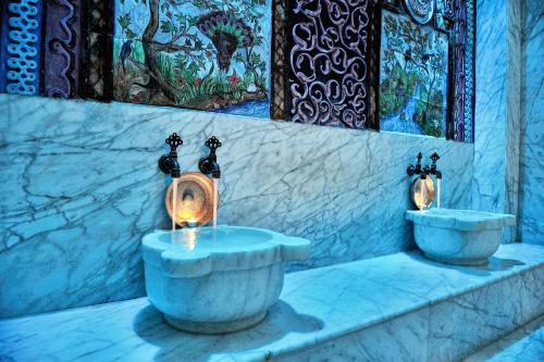 a bathroom with two faucets and two sinks at Gloria Verde Resort - Kids Concept in Belek