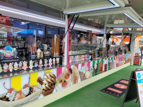 a store display with pastries and other food items at Gloria Stay - Aberystwyth Caravan in Aberystwyth