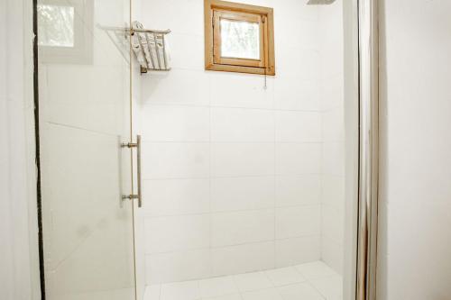 a shower with a glass door in a bathroom at Playa Venao Hotel Resort in Playa Venao