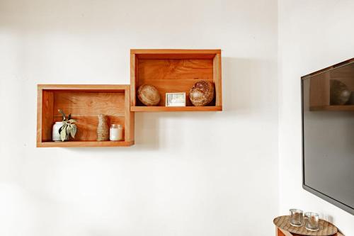 a wooden shelf with some objects on a wall at Playa Venao Hotel Resort in Playa Venao