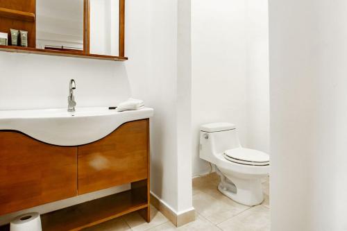 a bathroom with a sink and a toilet at Playa Venao Hotel Resort in Playa Venao