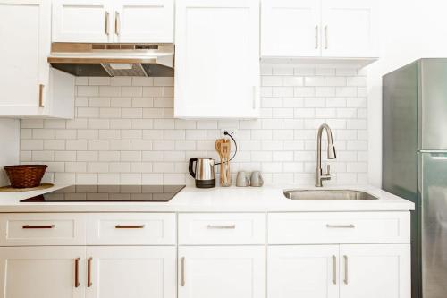 a white kitchen with white cabinets and a sink at Playa Venao Hotel Resort in Playa Venao