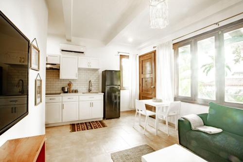 a kitchen with a couch and a table in a room at Playa Venao Hotel Resort in Playa Venao