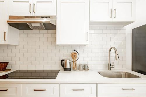 a kitchen with white cabinets and a sink at Playa Venao Hotel Resort in Playa Venao
