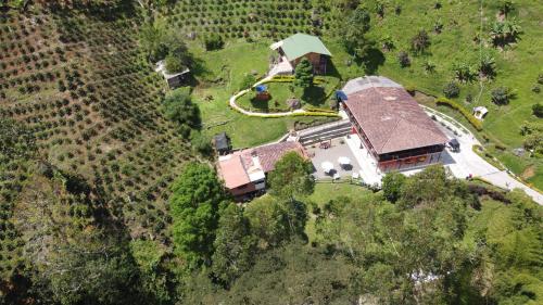 an aerial view of a house in a field at Hotel Orillas del Pizano in Jardin