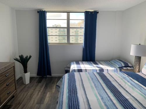 a bedroom with two beds and a window at Beach Apartment at Condo-hotel in Miami Beach