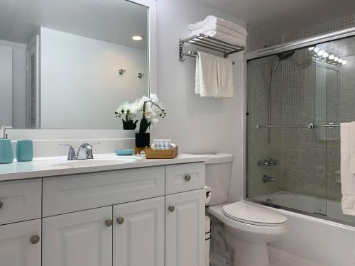 a bathroom with a sink and a toilet and a shower at Beach Apartment at Condo-hotel in Miami Beach