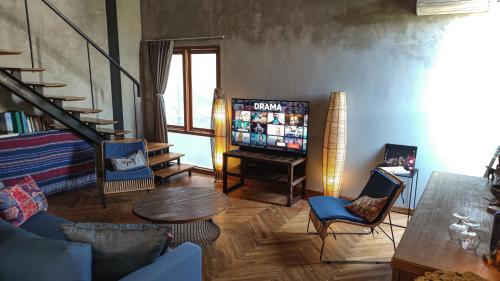 a living room with a couch and a table at Ruang Tekuni in Legian