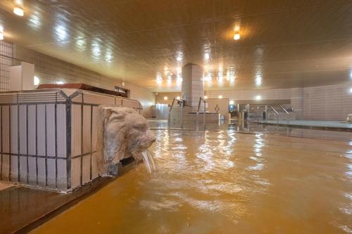 an elephant is standing in water in a building at Kirishima Kokusai Hotel in Kirishima