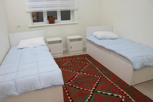 Un ou plusieurs lits dans un hébergement de l'établissement Guest House Semetei