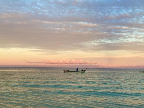 two people in a boat in the ocean at Mambo Paradise in Matemwe