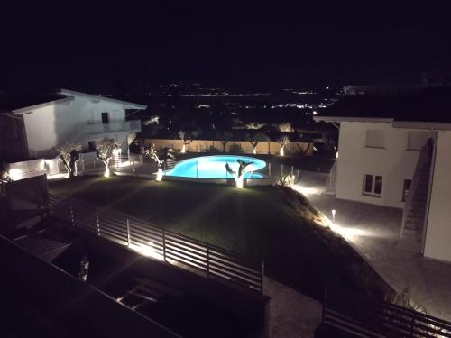 a view of a pool at night with lights at Bilocale in residence vista lago con piscina in Polpenazze del Garda