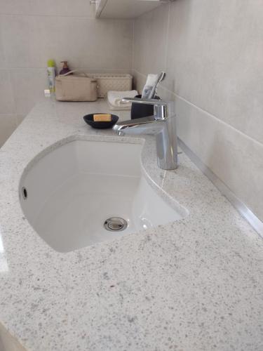 a white counter top with a sink in a bathroom at Bilocale in residence vista lago con piscina in Polpenazze del Garda