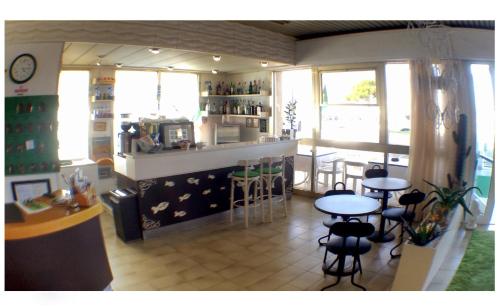 a restaurant with tables and chairs in a room at Hotel Ariston in Cesenatico