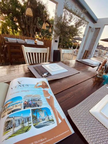 a table with a magazine on top of it at Venus Resort in Tsilivi