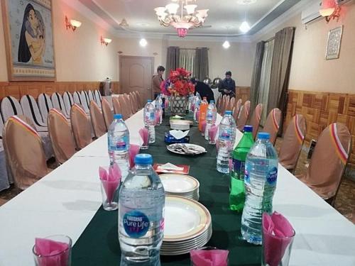 a long table with bottles of water on it at Happy Stay Guest House in Abbottābād