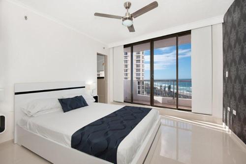 a hotel room with a large bed and a large window at Surfers International Apartments in Gold Coast
