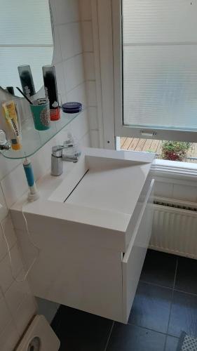 a white counter in a bathroom with a window at MICHELLE, not for parties, not a hotel, room with shared bathroom, no kitchen in Amsterdam