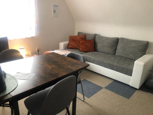 a living room with a couch and a table at Scharfs Kämmerla in Baiersdorf
